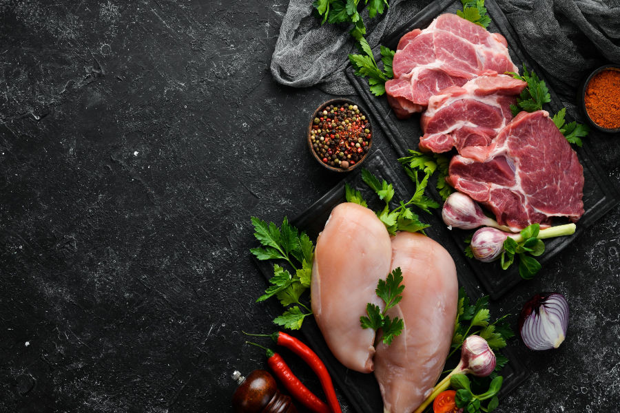 meat and spices in a black background