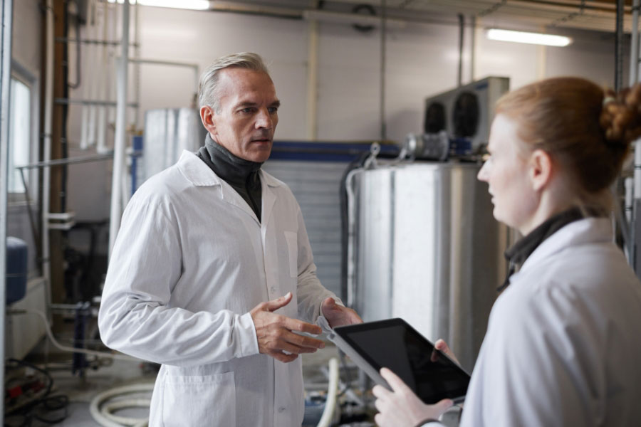 production manager instructing trainee at dairy production