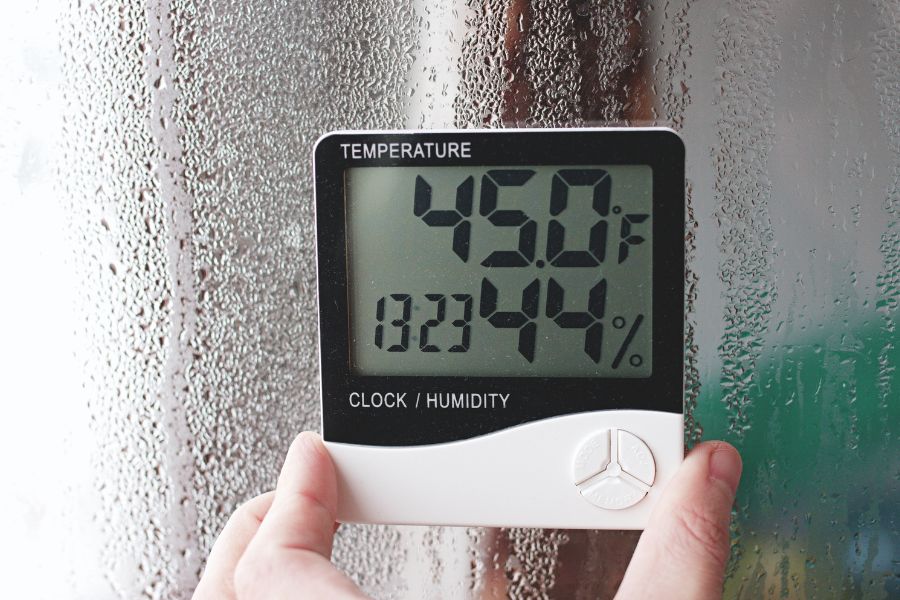 worker checking temperature and humidity in factory