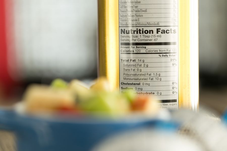 nutrition label in canned food with blurred fruit salad