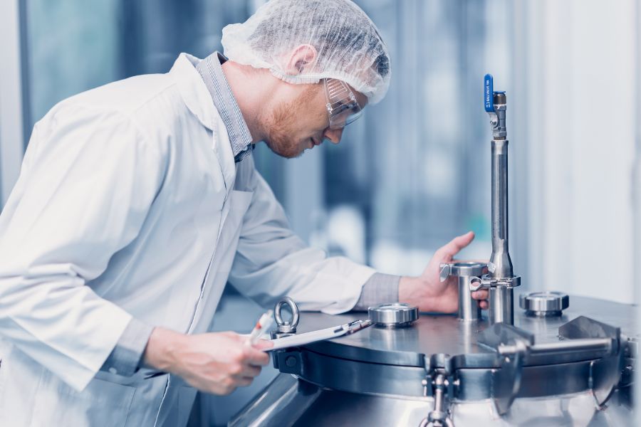 factory worker checking the pressure of the machine