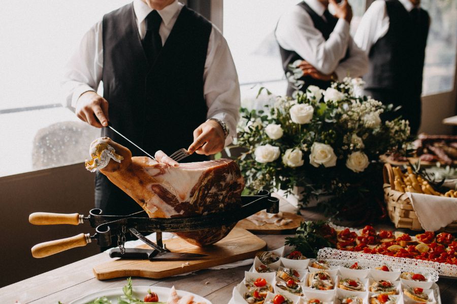 food server taking food using fork and knife