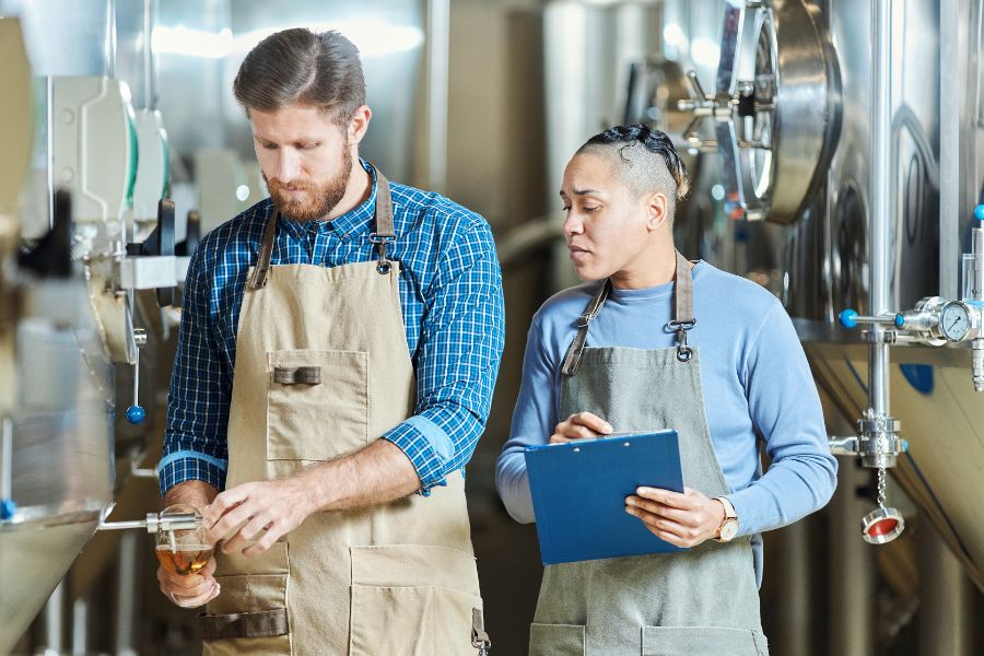 brewmasters inspecting quality of productions